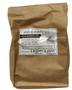 Brun papirpose med label fra JADALIGHT PRO, mærket til professionel brug. Etiketten angiver tekniske specifikationer for RGBY-lyskæde, IP67-klassifikation samt producentoplysninger fra Jada Group.