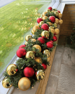 Elegant granguirlande med røde og champagne kugler samt små LED-lys. Skaber et varmt og klassisk juleudtryk i vindueskarmen med eksklusiv og stemningsfuld glans.